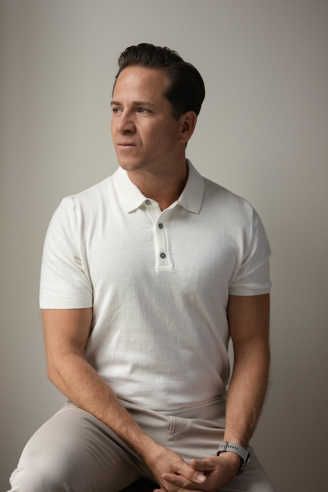 Dr. Isaac Jones in a white polo, looking off to the side