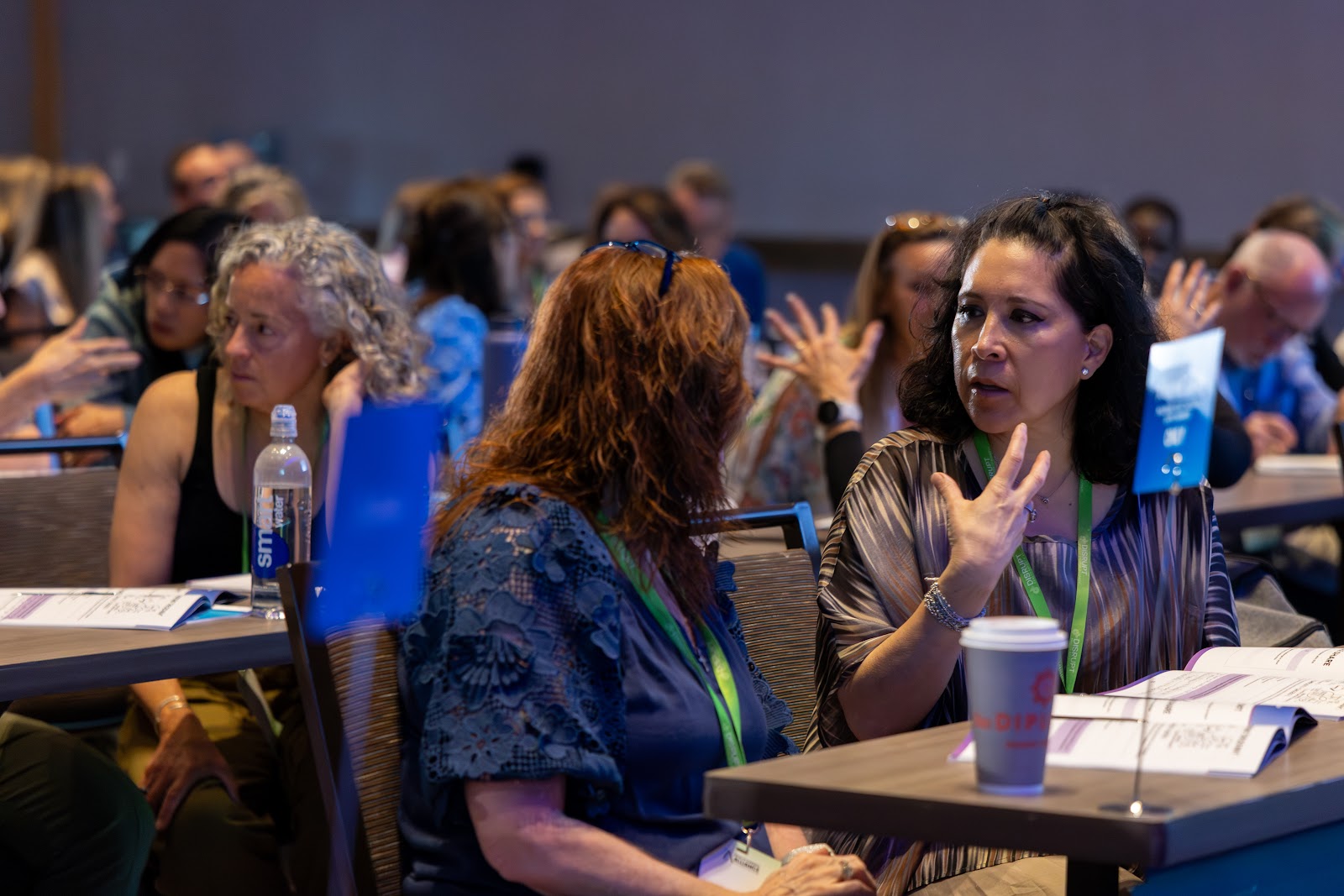 Practitioners talking through ideas at a Disrupt workshop table