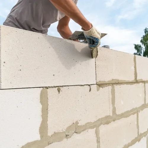 Masonry contractor in Sugar Land, TX completing a brick and stone installation