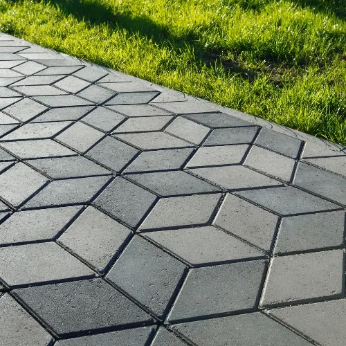 Close-up of concrete crack repair in Sugar Land, TX with sealed joint and blended patch