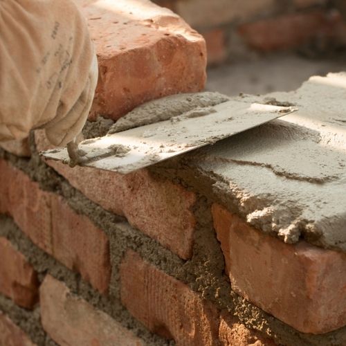 Masonry contractor in Fresno, TX building a clean brick wall