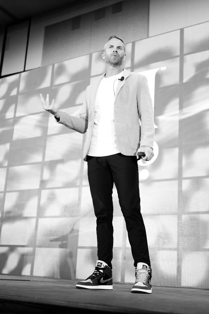 Rob Sperry on stage, black and white