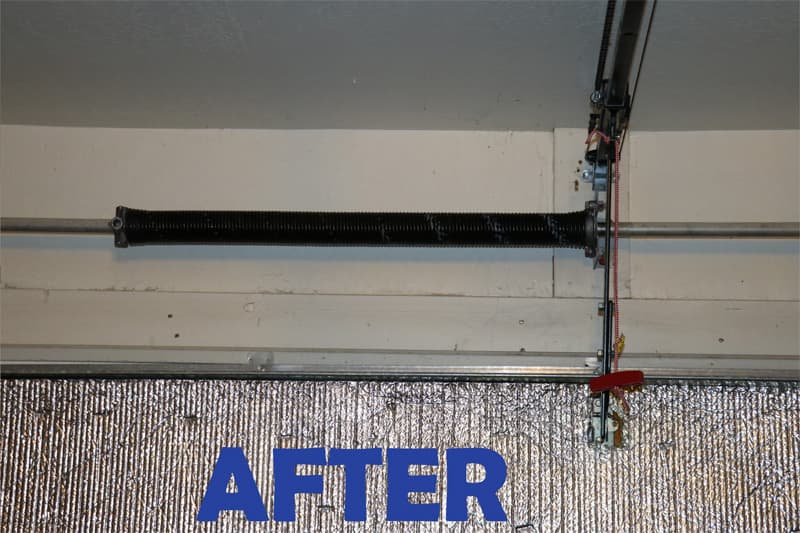 Garage door torsion spring system after spring replacement