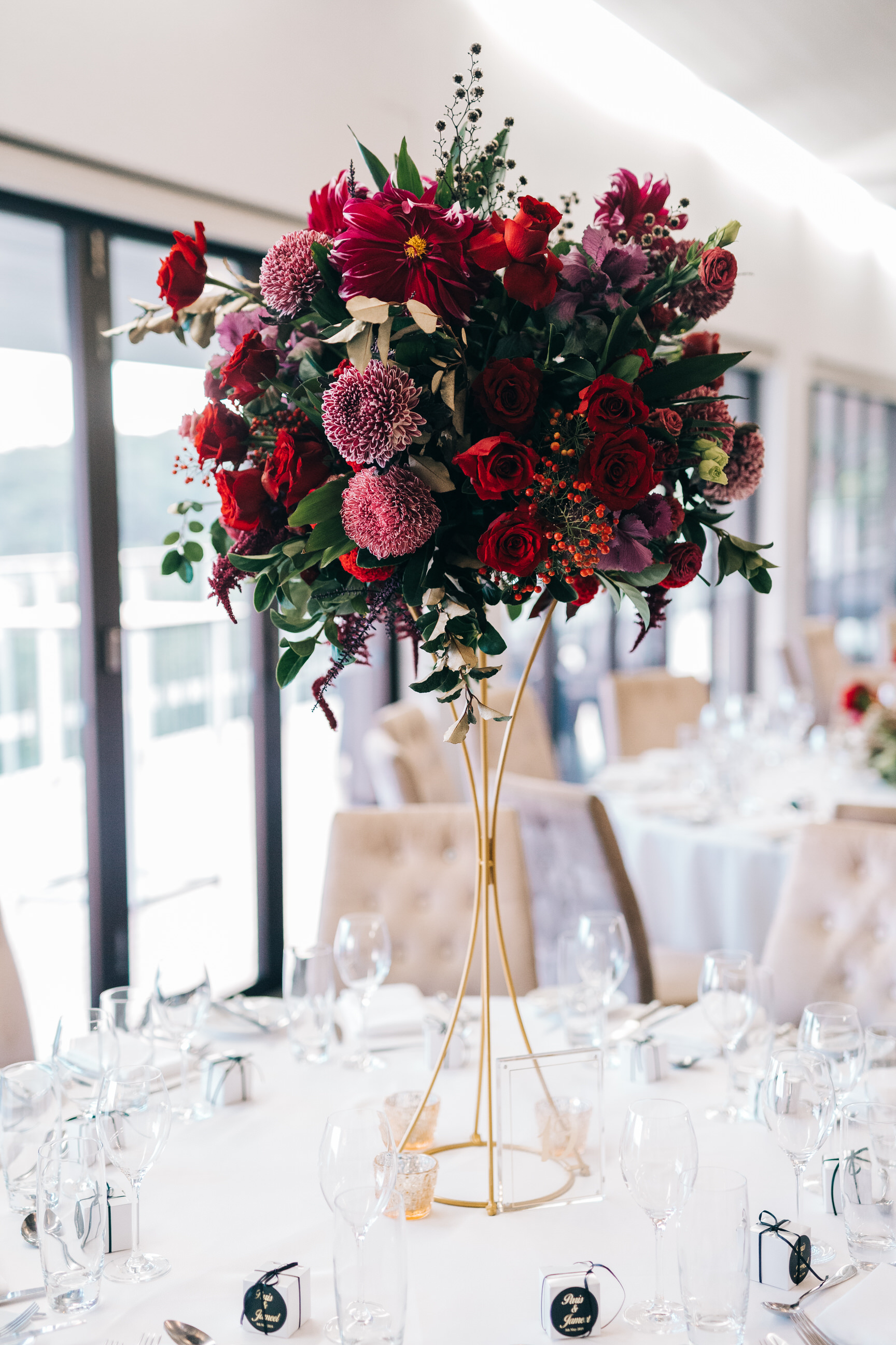 Tall burgundy centrepiece on a gold stand