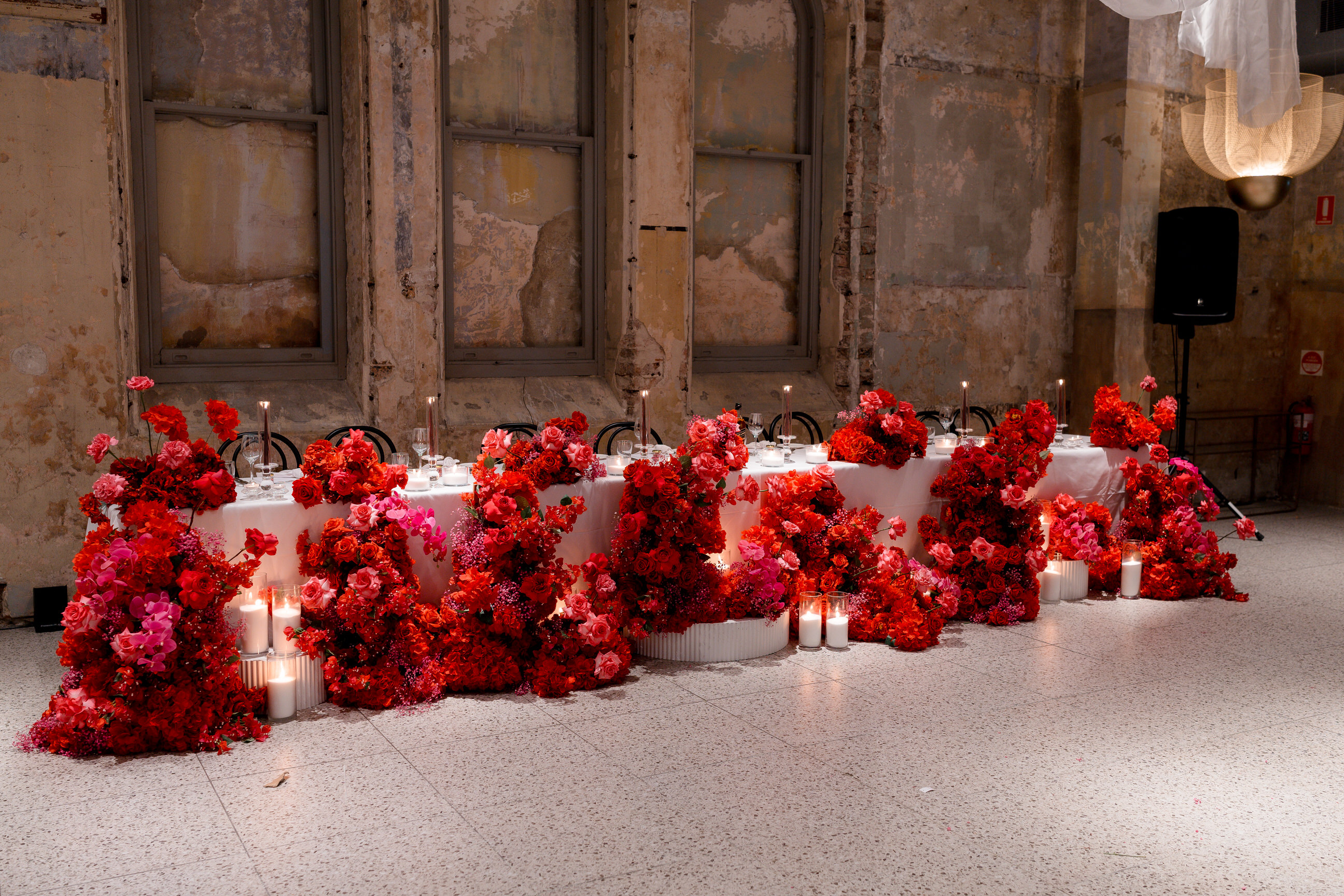 Deep red bridal table florals in a heritage room
