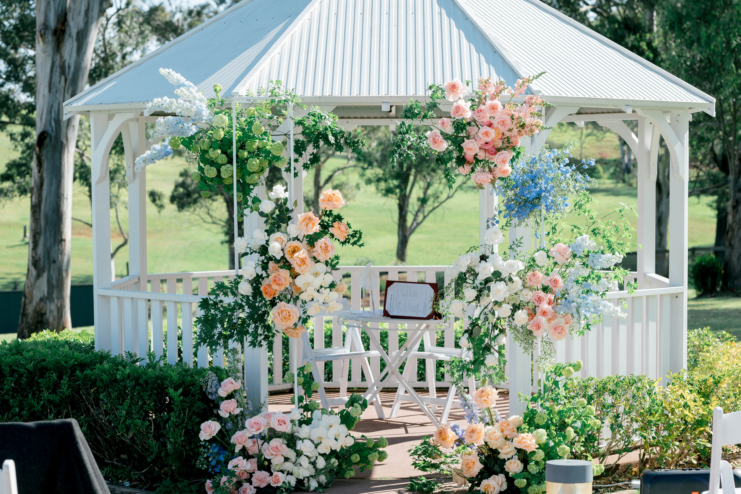 Garden gazebo styled with peach and blue florals