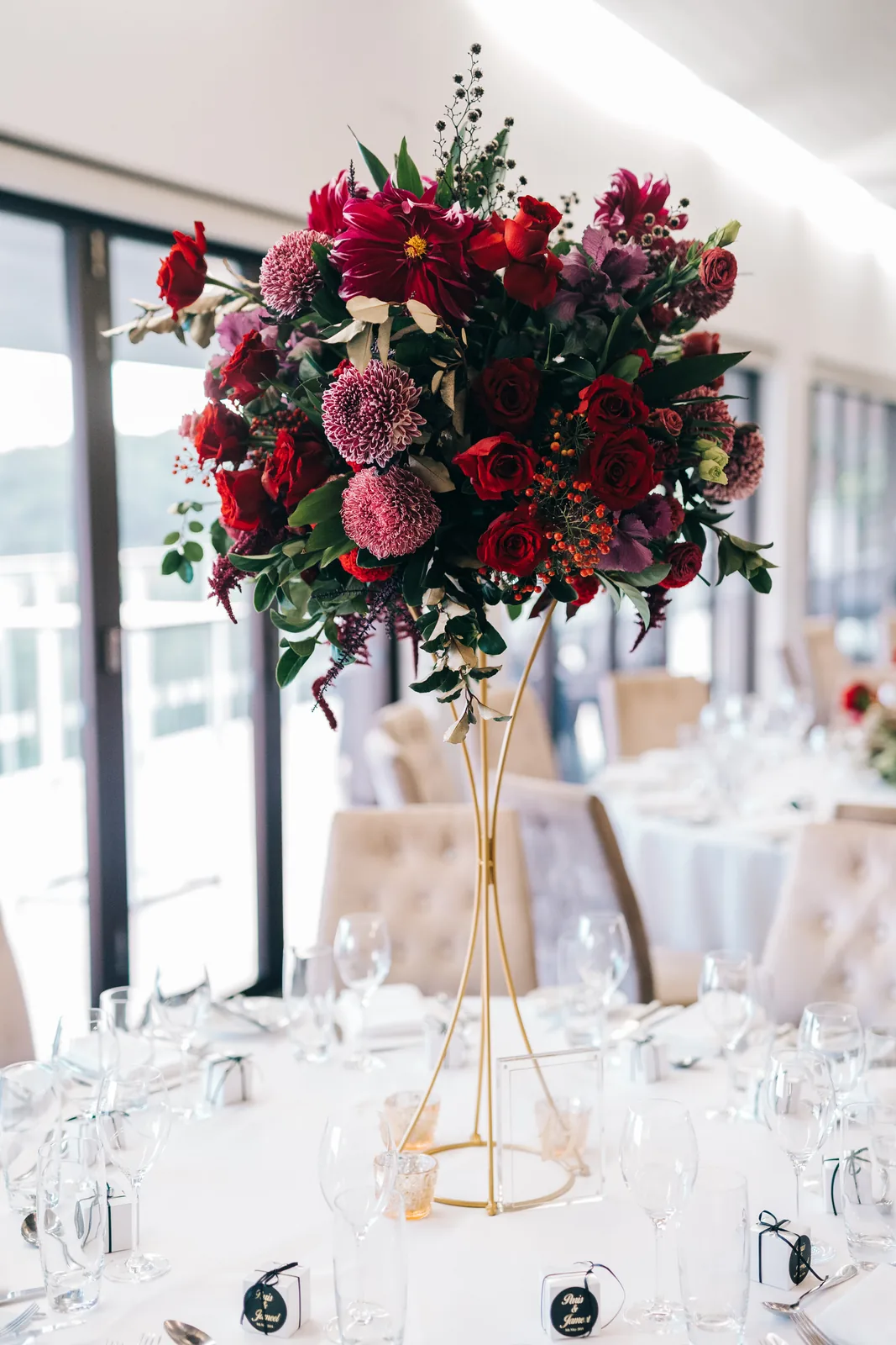 Tall burgundy centrepiece on a gold stand