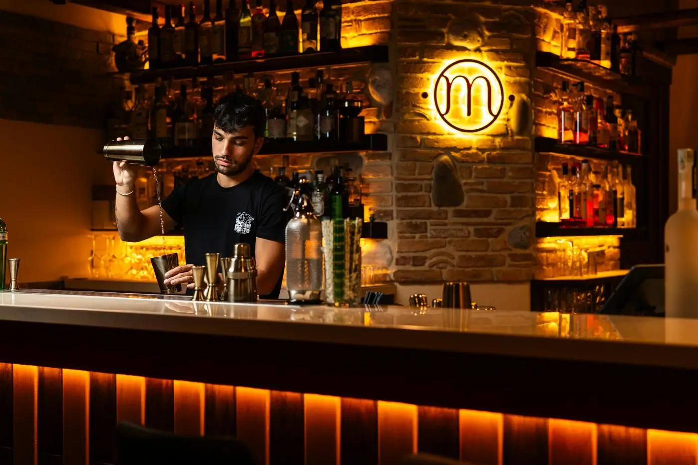 Bartender preparing drinks inside a local venue