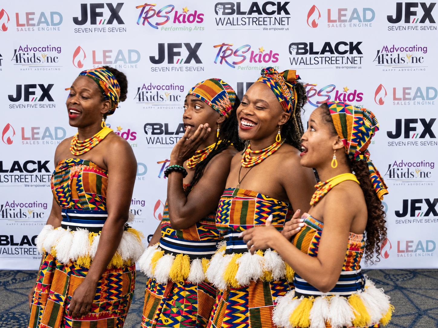 JFX 757 entertainers in front of branded backdrop