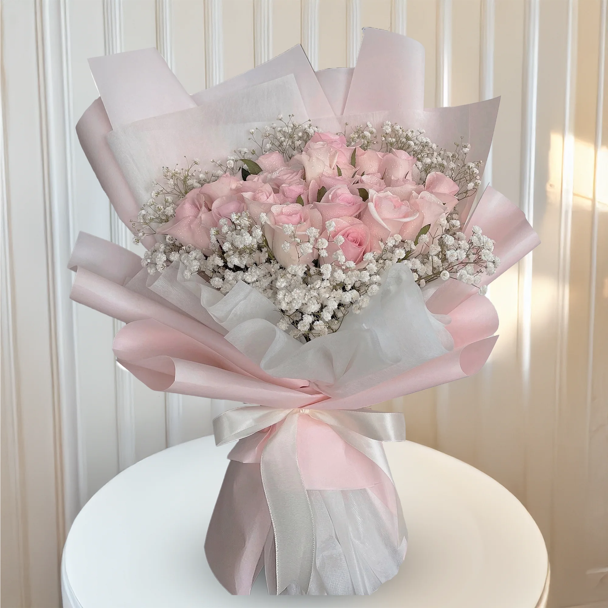 Soft pink rose bouquet wrapped in blush paper
