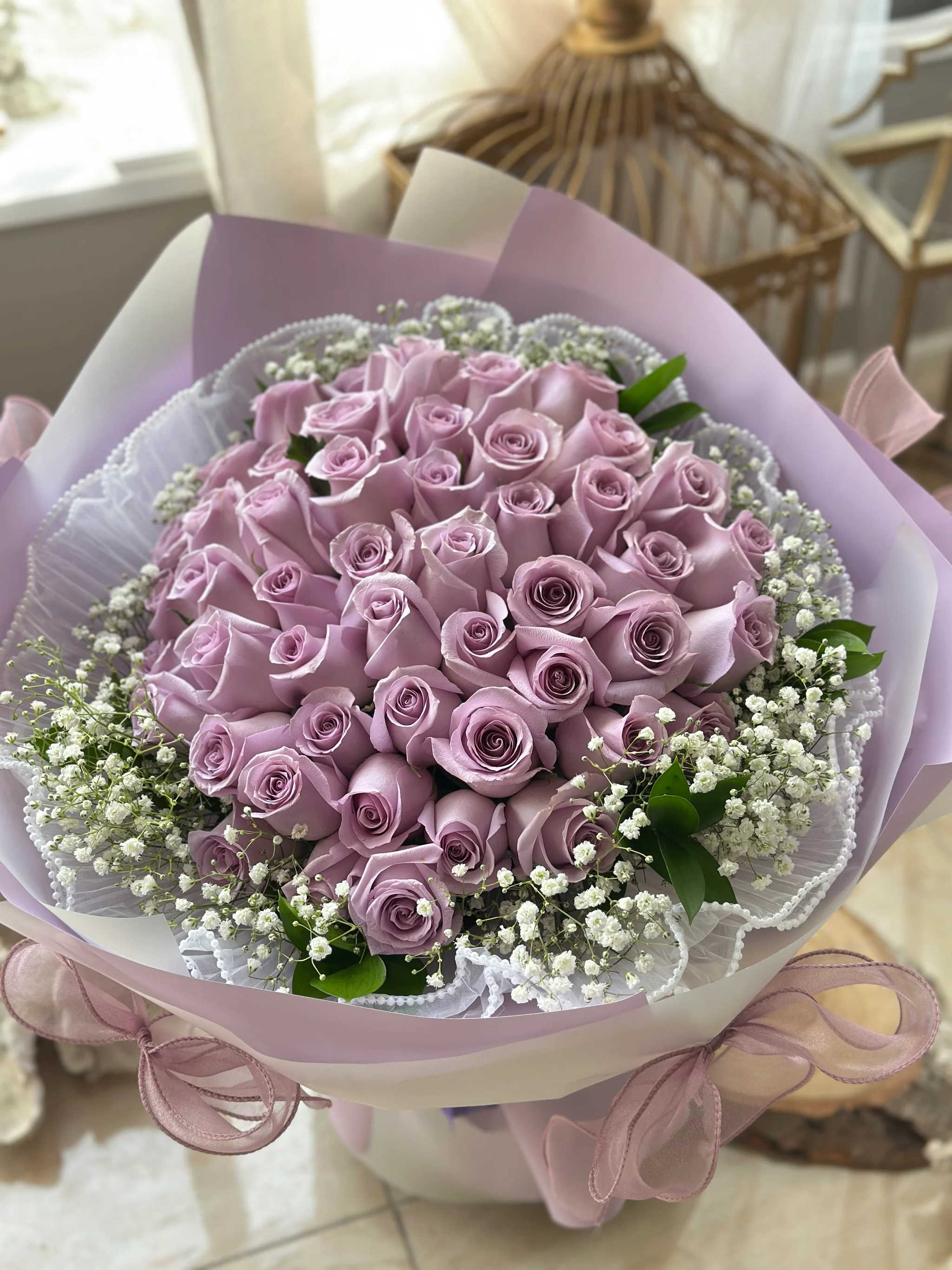 Lavender roses surrounded by baby's breath