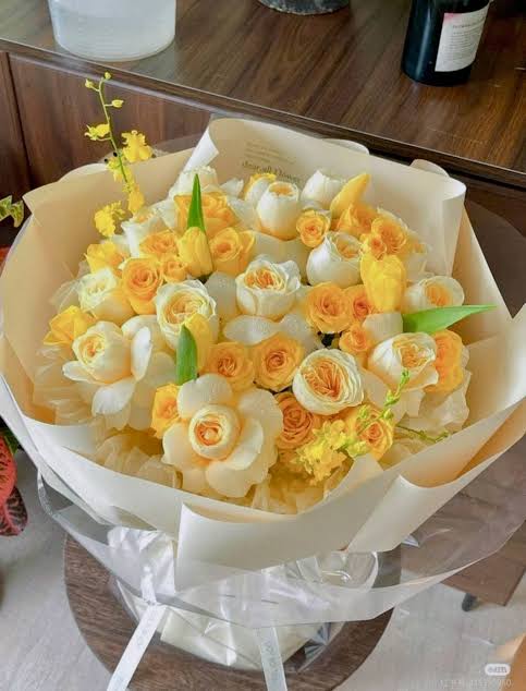 White and yellow rose bouquet with pastel wrapping