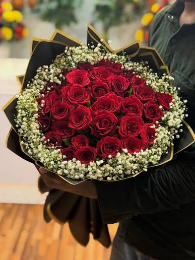 Red roses in black and gold bouquet wrapping
