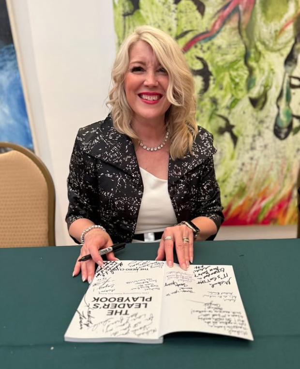 Tricia Benn signing copies of The Leader's Playbook