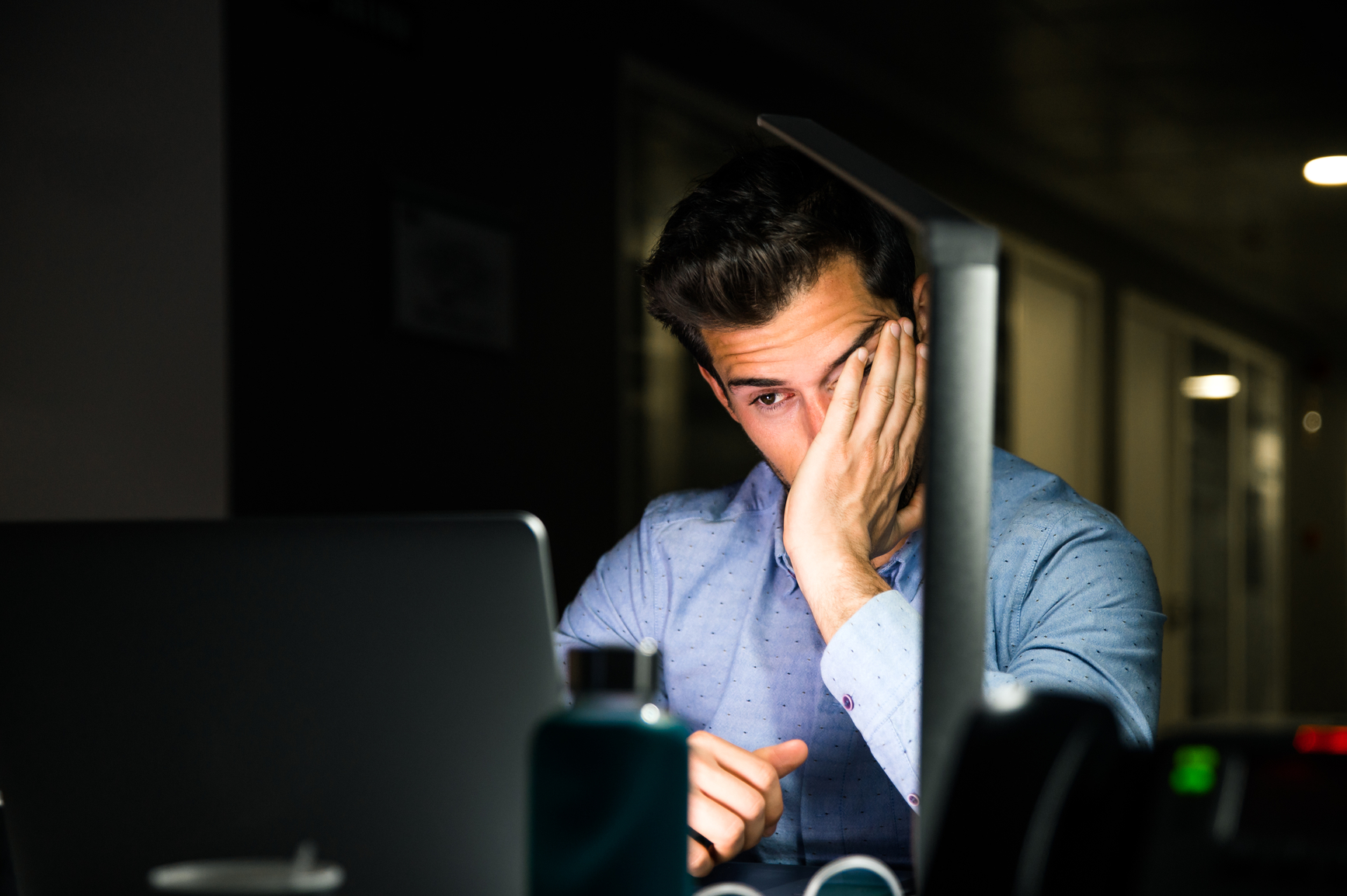 An expert working late, overwhelmed