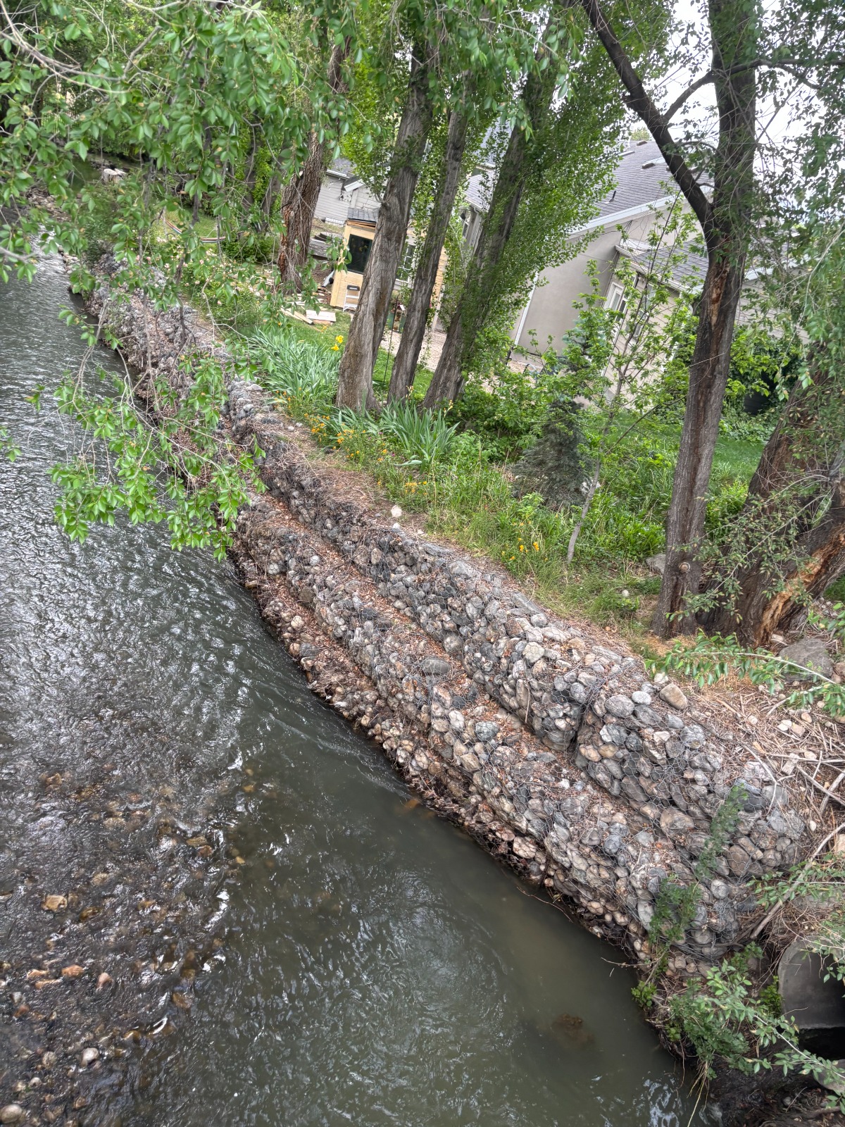 Salt Lake City creek-front property with gabion retaining walls — example of a complex property Peter evaluates