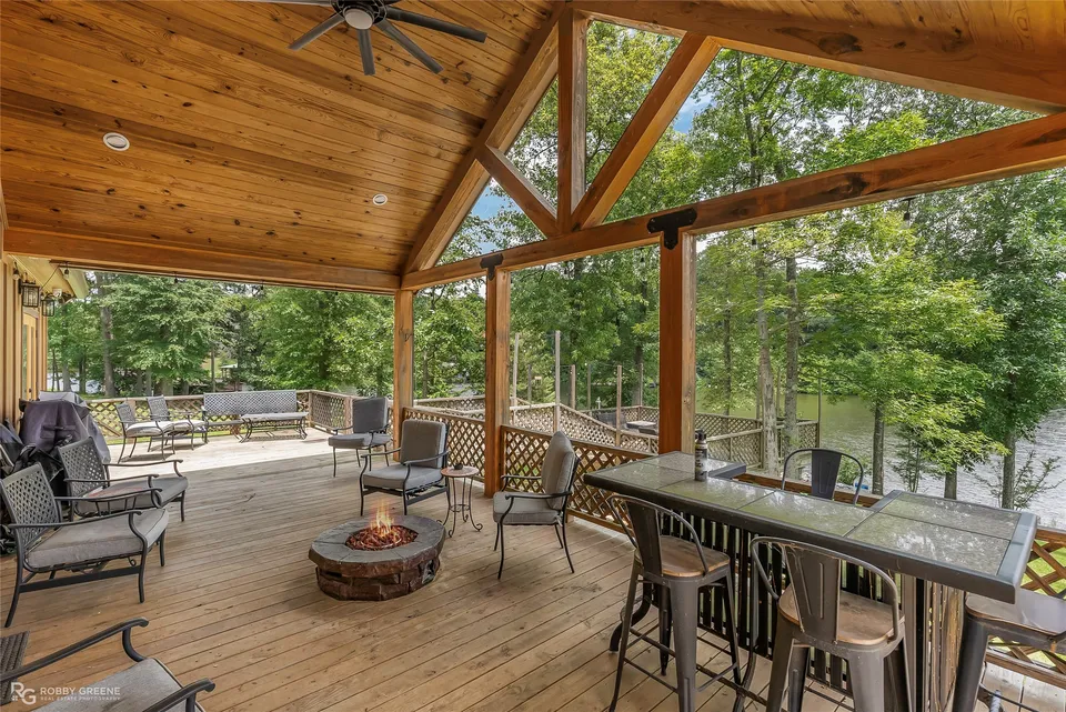 Covered deck with cypress beams overlooking the lake
