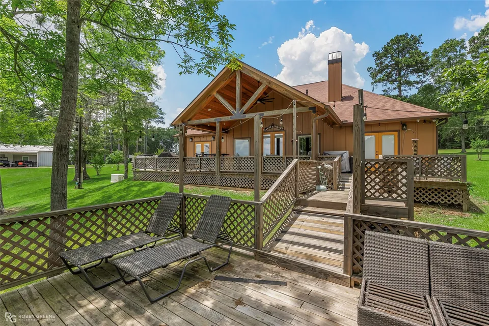 Home and covered deck viewed from the lakeside yard