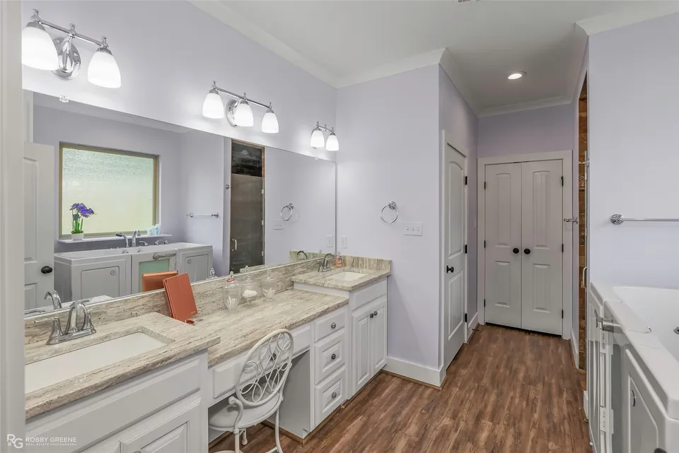 Primary bathroom with two sinks and a shower