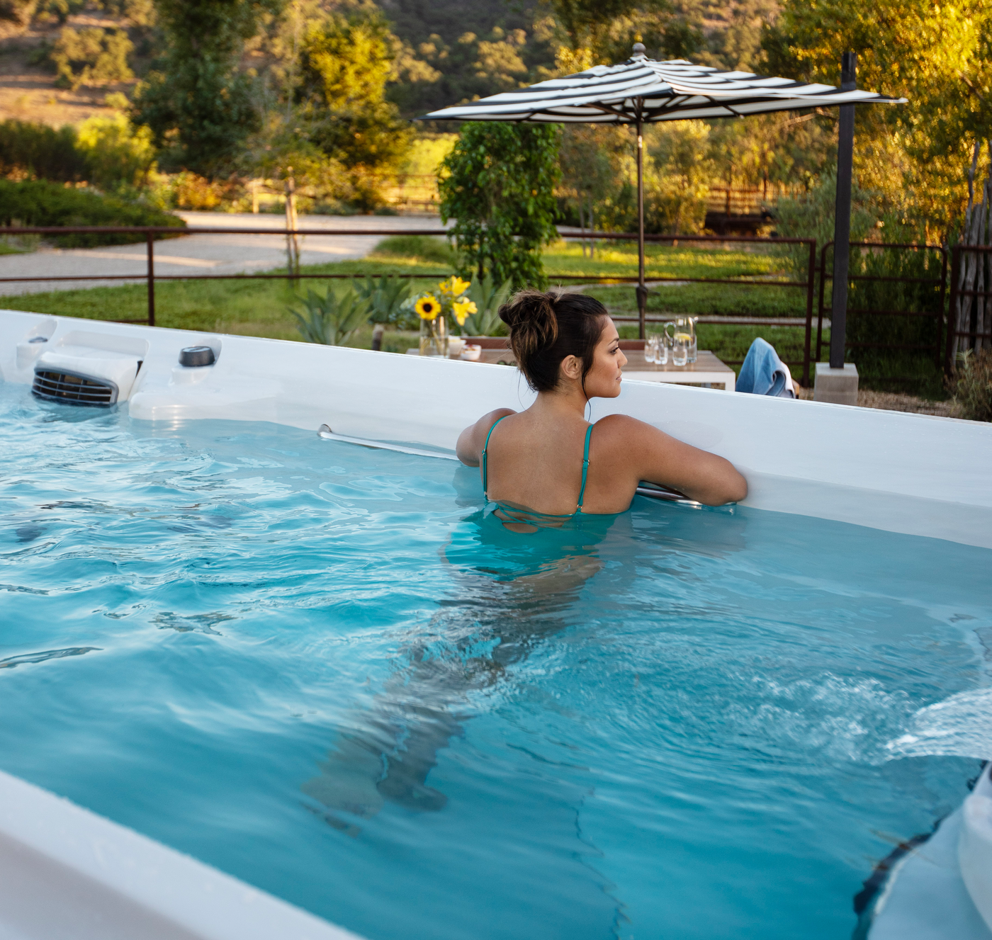 Jacuzzi® swim spa in a landscaped backyard