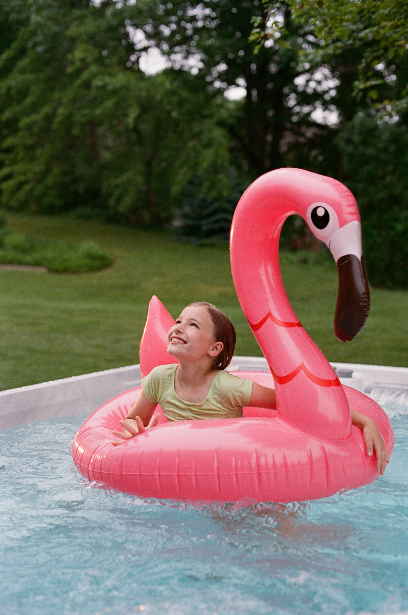 Child enjoying a Sundance® swim spa with a colorful pool float