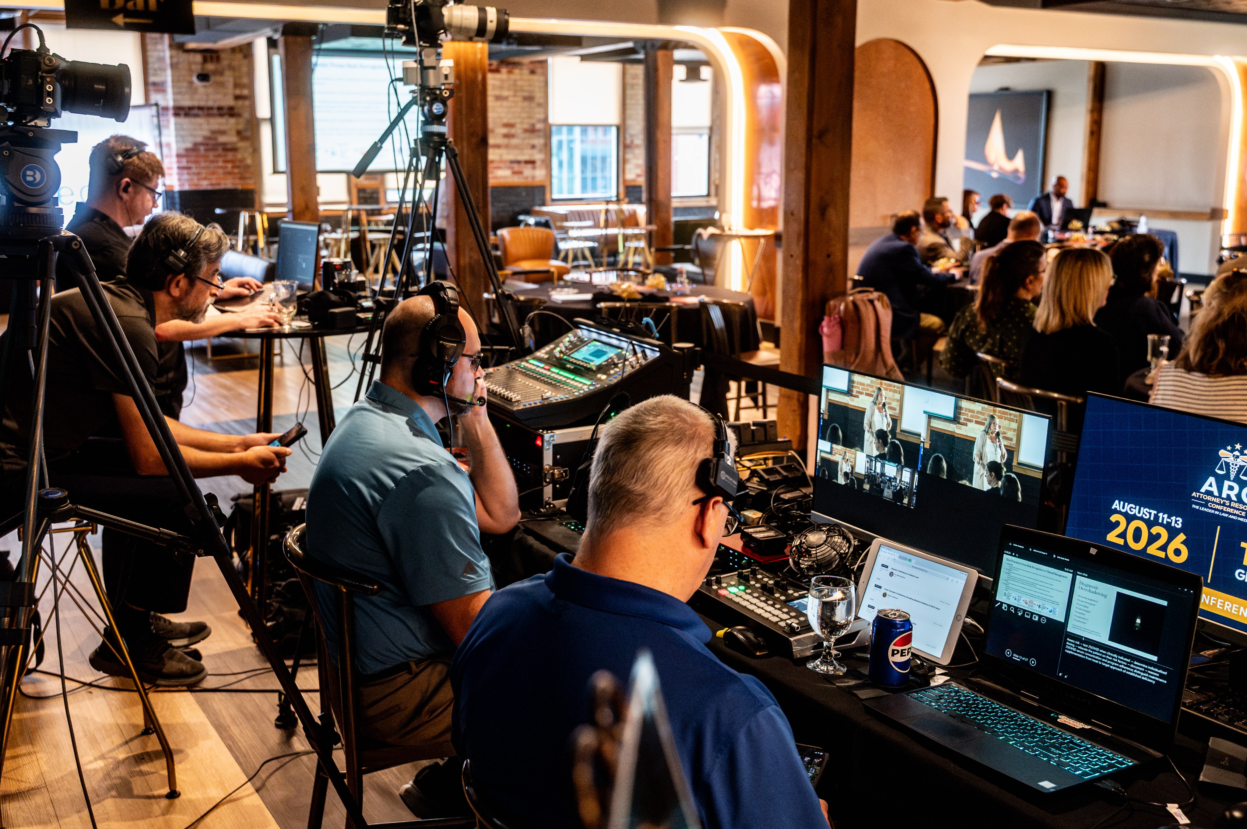 The production area at the Attorneys Resource Conference 2026, several operators at monitors and mixers