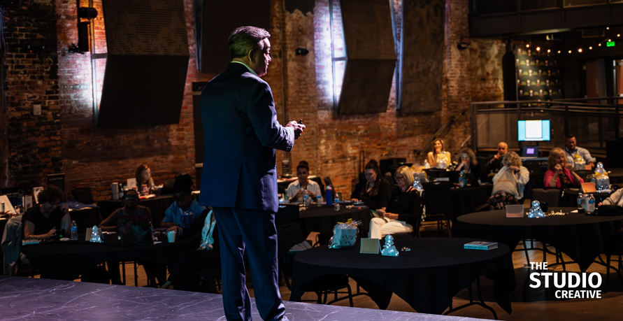 Keynote speaker on stage — filmed by The Studio Creative