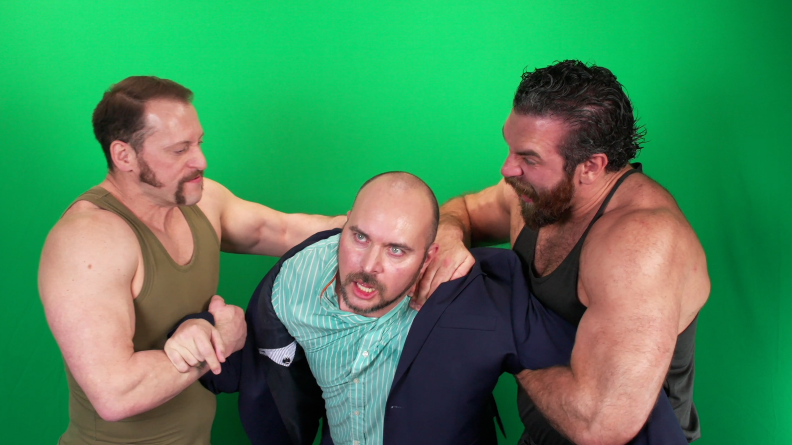 The same frame on set: the three performers in front of the green screen
