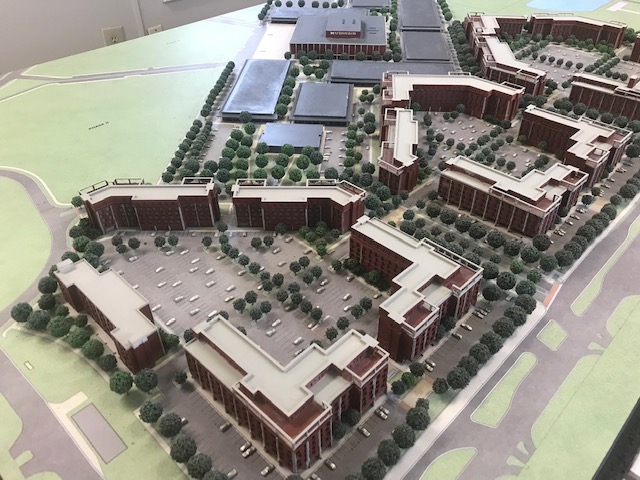 Detail of the scale model showing apartment blocks, streets, parked cars and landscaping