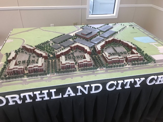 The full Northland City Center scale model on a table skirted with the development's branding