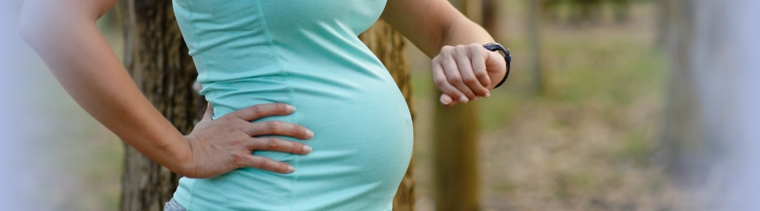 can you run while pregnant - expecting mother in activewear considering her workout options