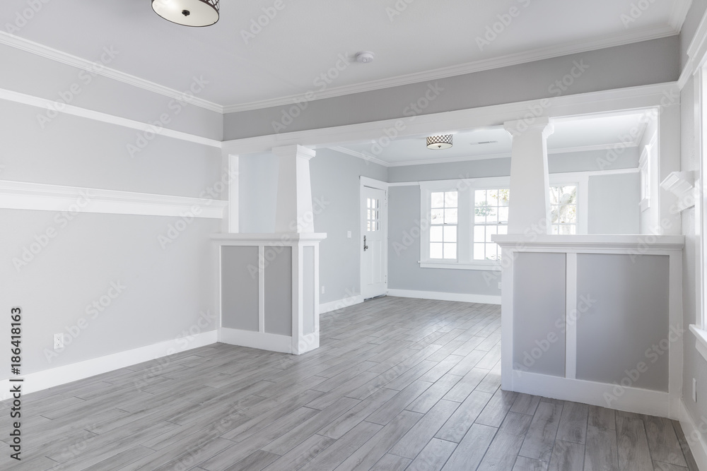 Interior painting project with two-tone gray walls, white trim, and finished millwork detailing.