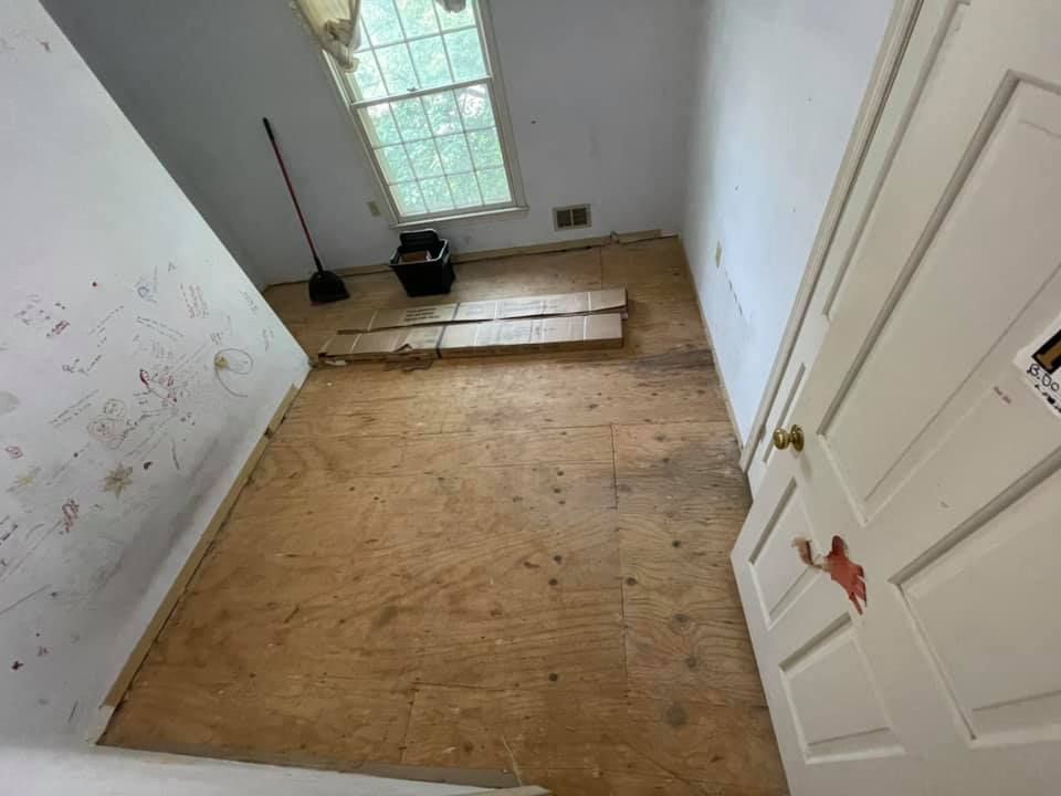 Before flooring replacement showing existing room flooring condition