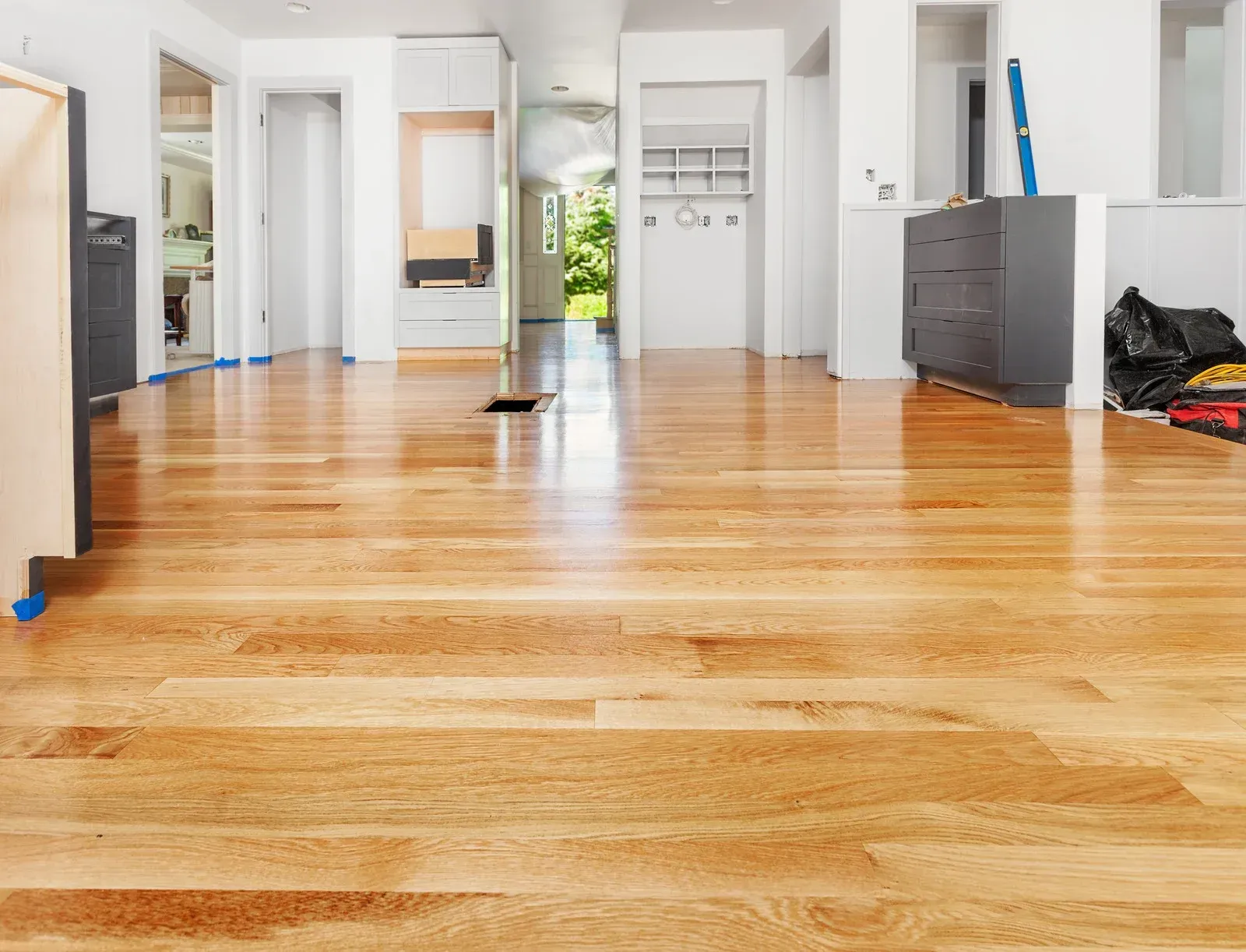 Finished hardwood flooring in a bedroom with tight wall cuts, clean baseboard lines, and uniform gloss