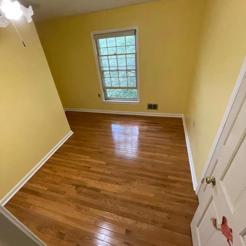 After flooring upgrade showing completed hardwood-style floors and stairs