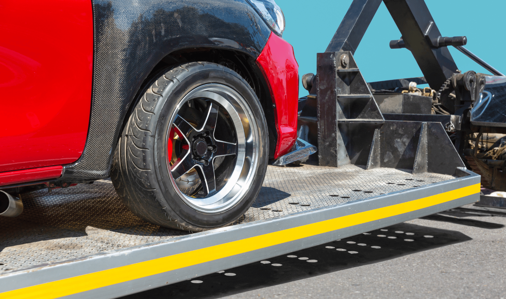 Car securely strapped on a tow truck