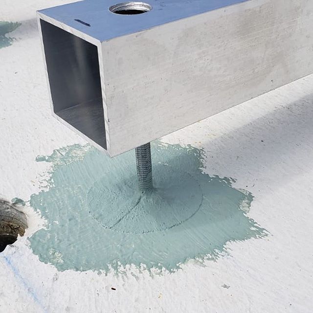 Sealed penetration detail on a coated roof