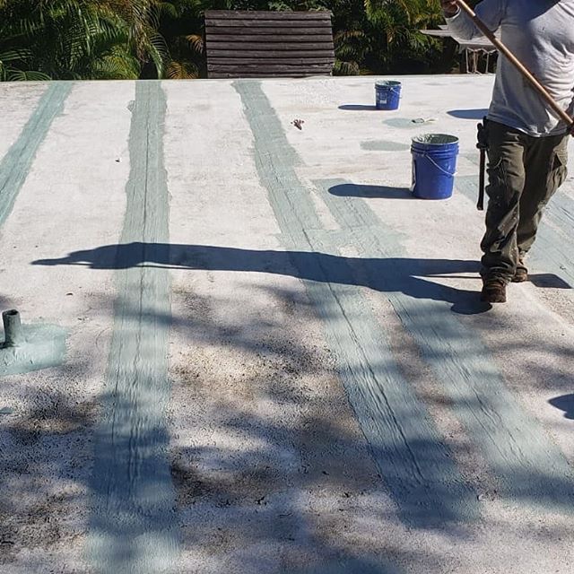 Coating over an asphaltic roof system