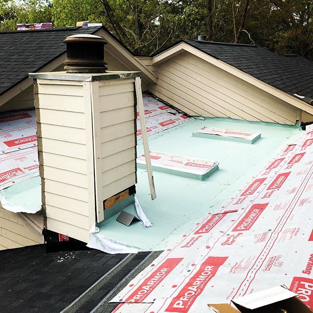 Residential roof detail with chimney and underlayment