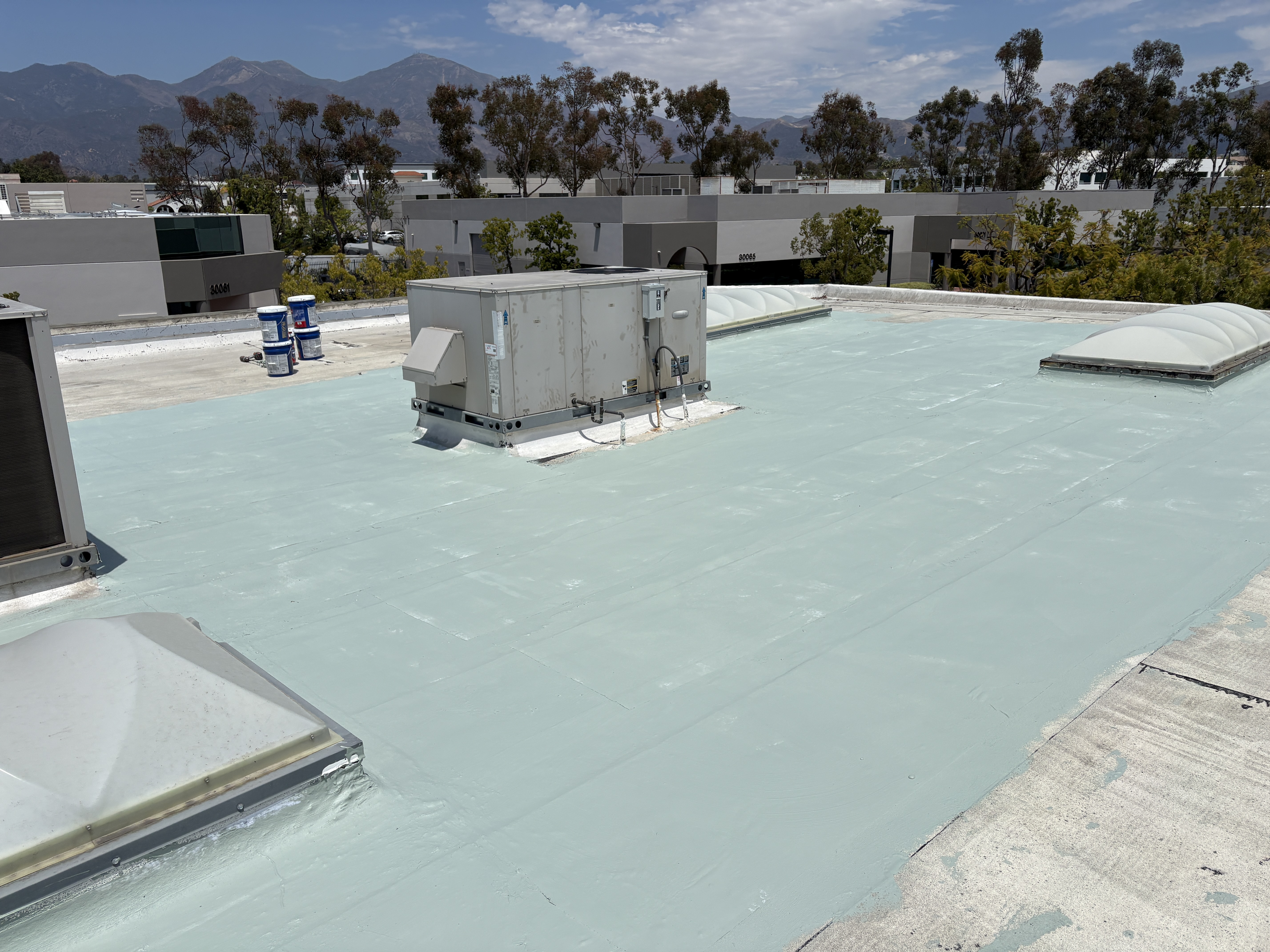 White coated roof built to shed ponding water