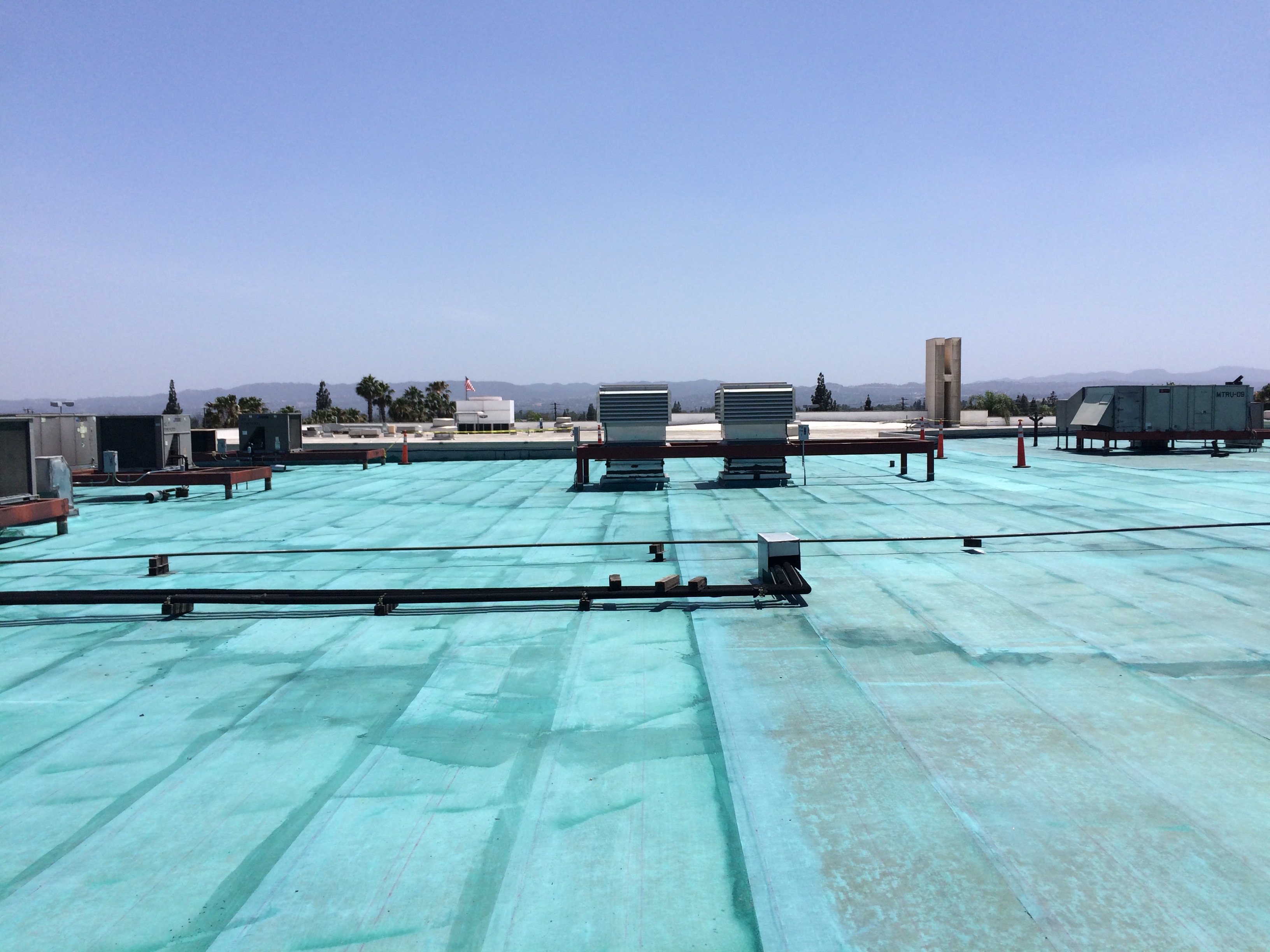 Coated roof with HVAC equipment