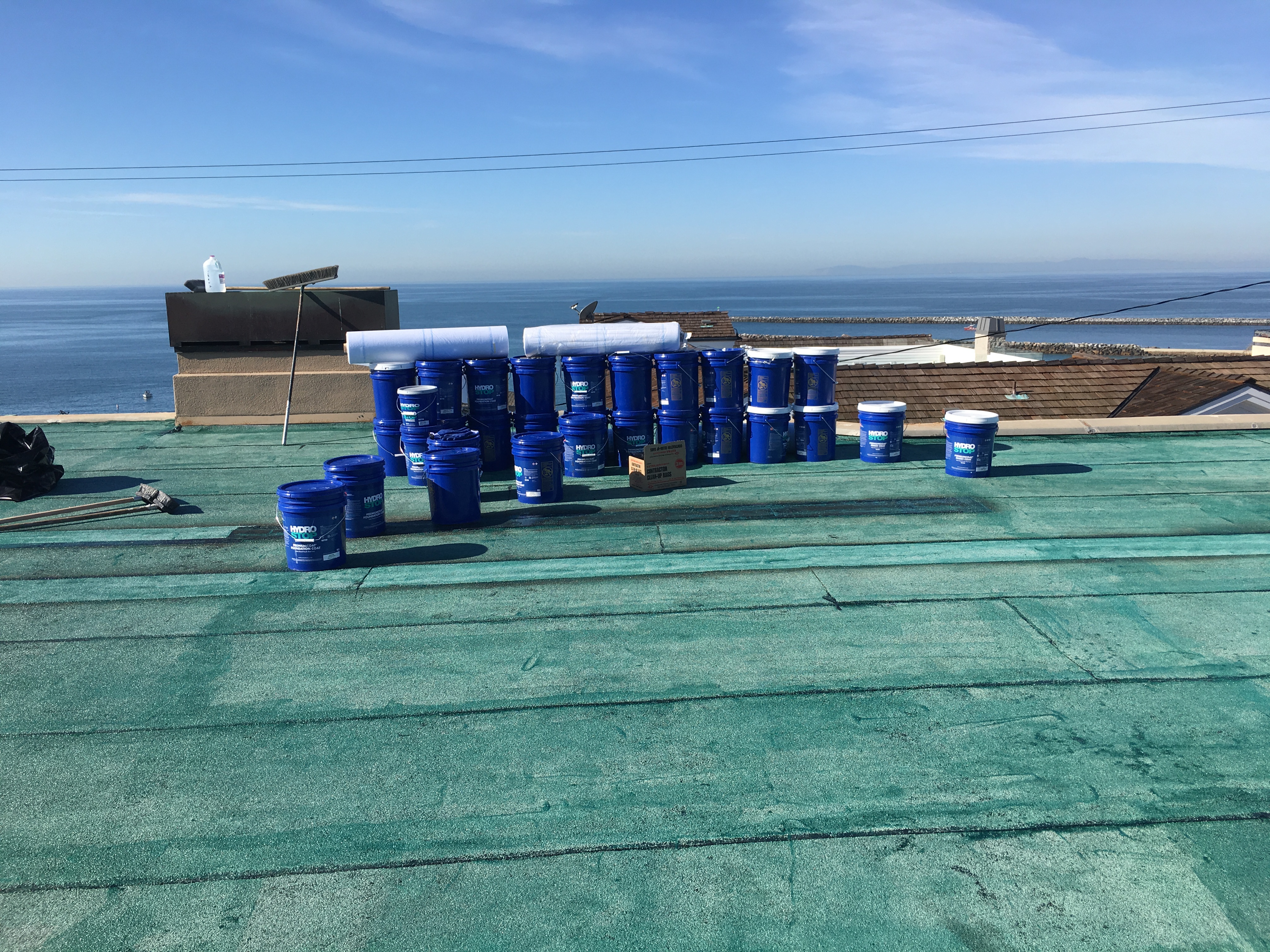 Product buckets staged with an ocean backdrop