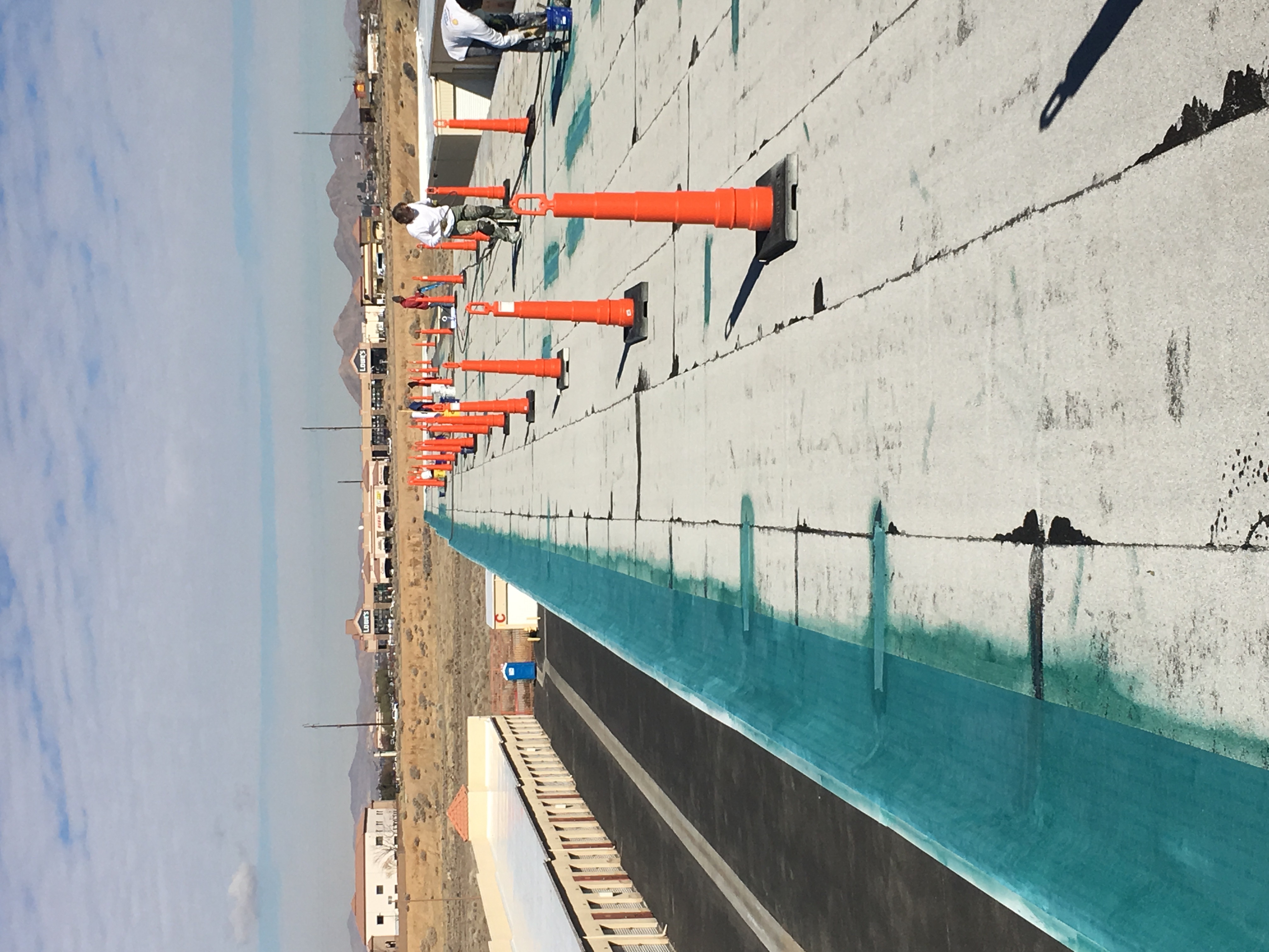 Crew working a long desert commercial roof