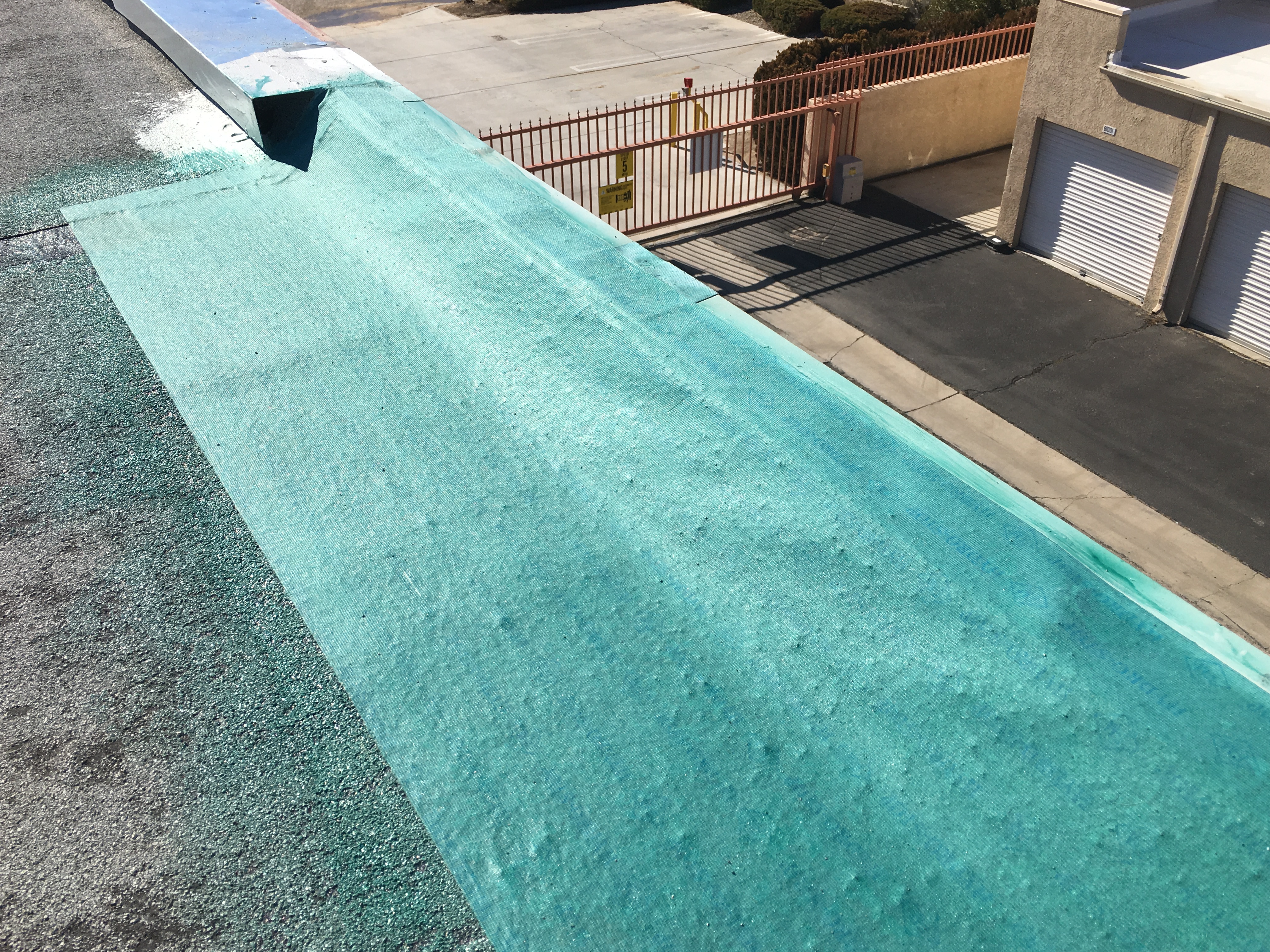 GAF primer application on a commercial roof substrate