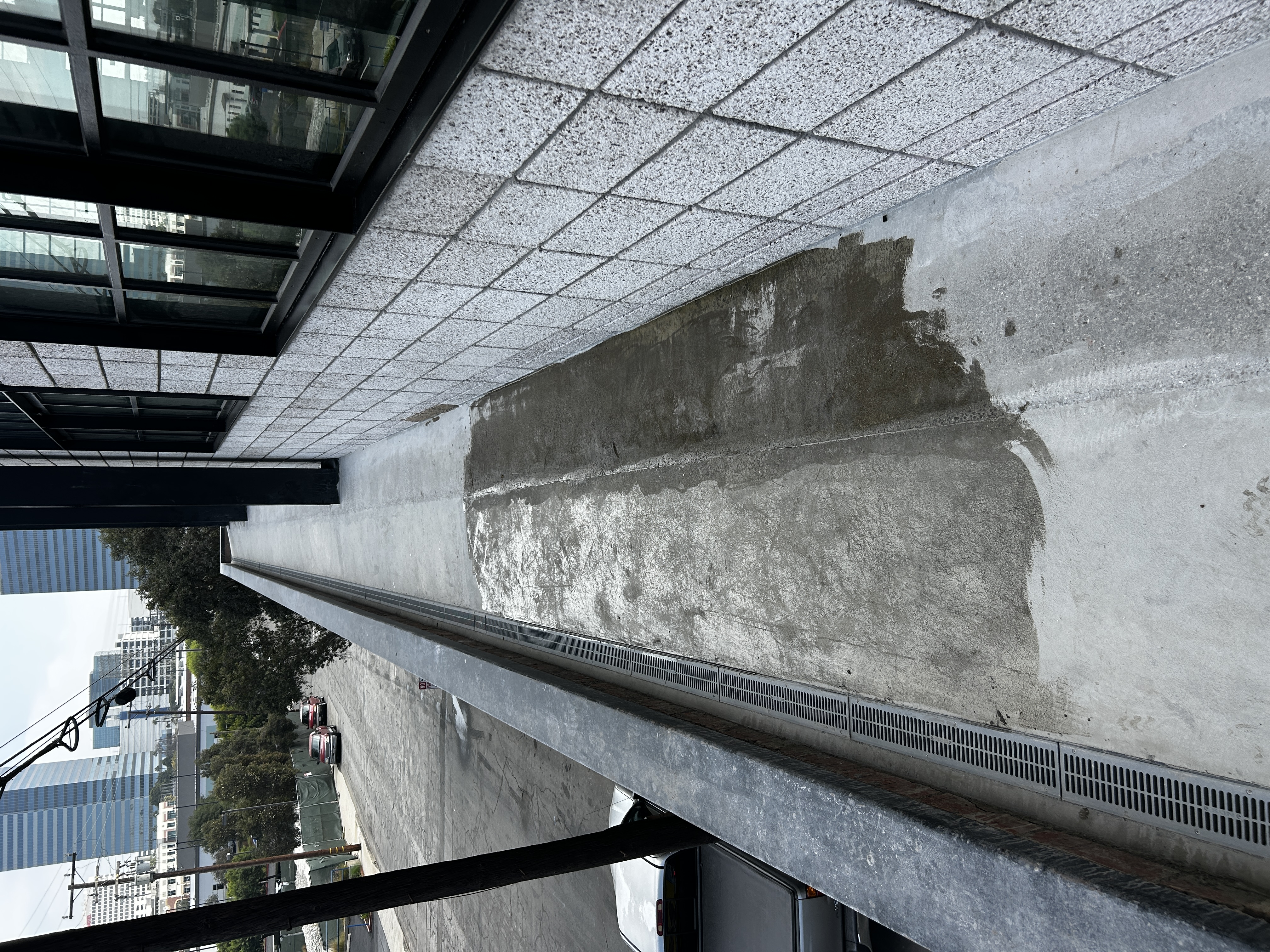 Primer applied along a rooftop walkway