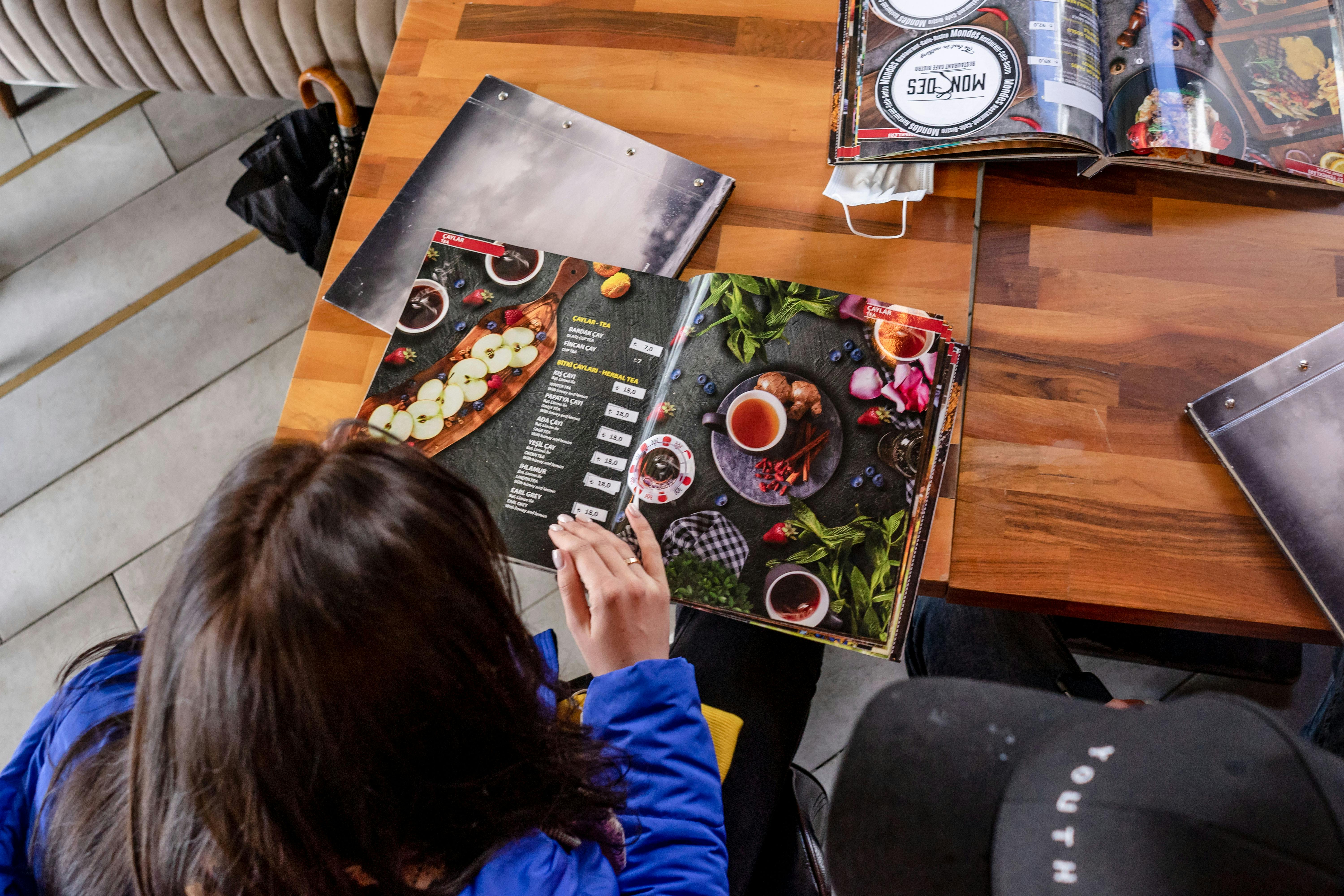 Restaurant menu being read by guest
