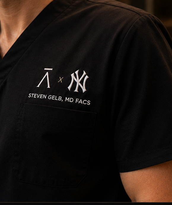 Close-up of the Formari Aesthetics New York consult edition embroidery on black scrubs.