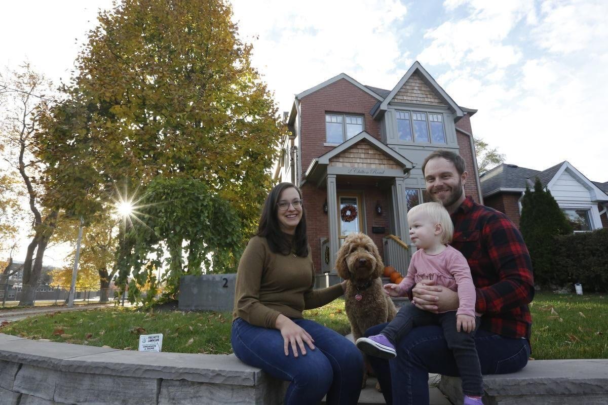 A family in front of their finished BVM addition in East York
