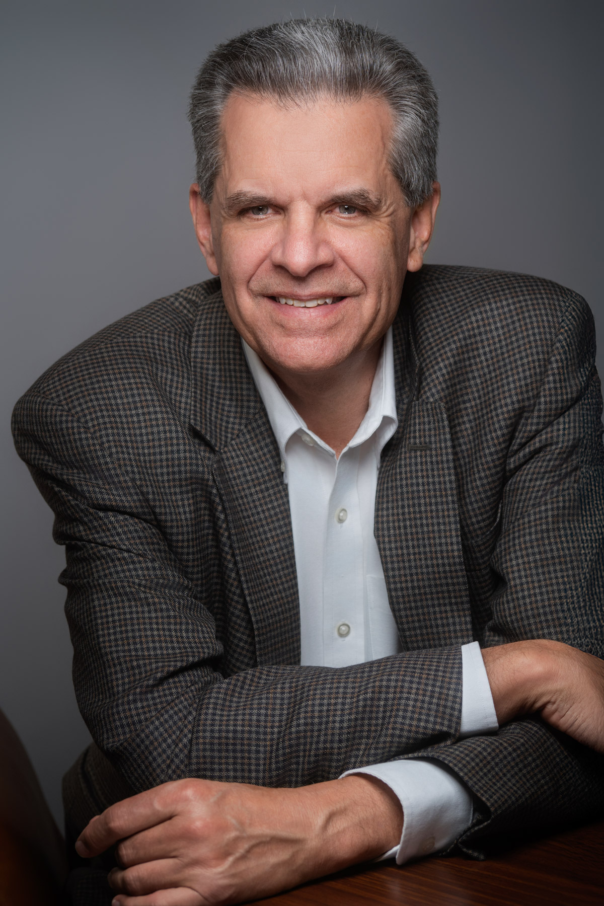 Professional headshot of a Charleston realtor in a blazer, smiling confidently