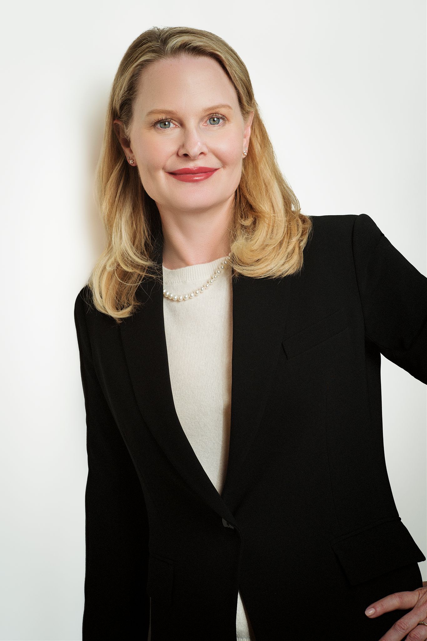 Professional headshot of a Charleston realtor in a blazer, smiling confidently